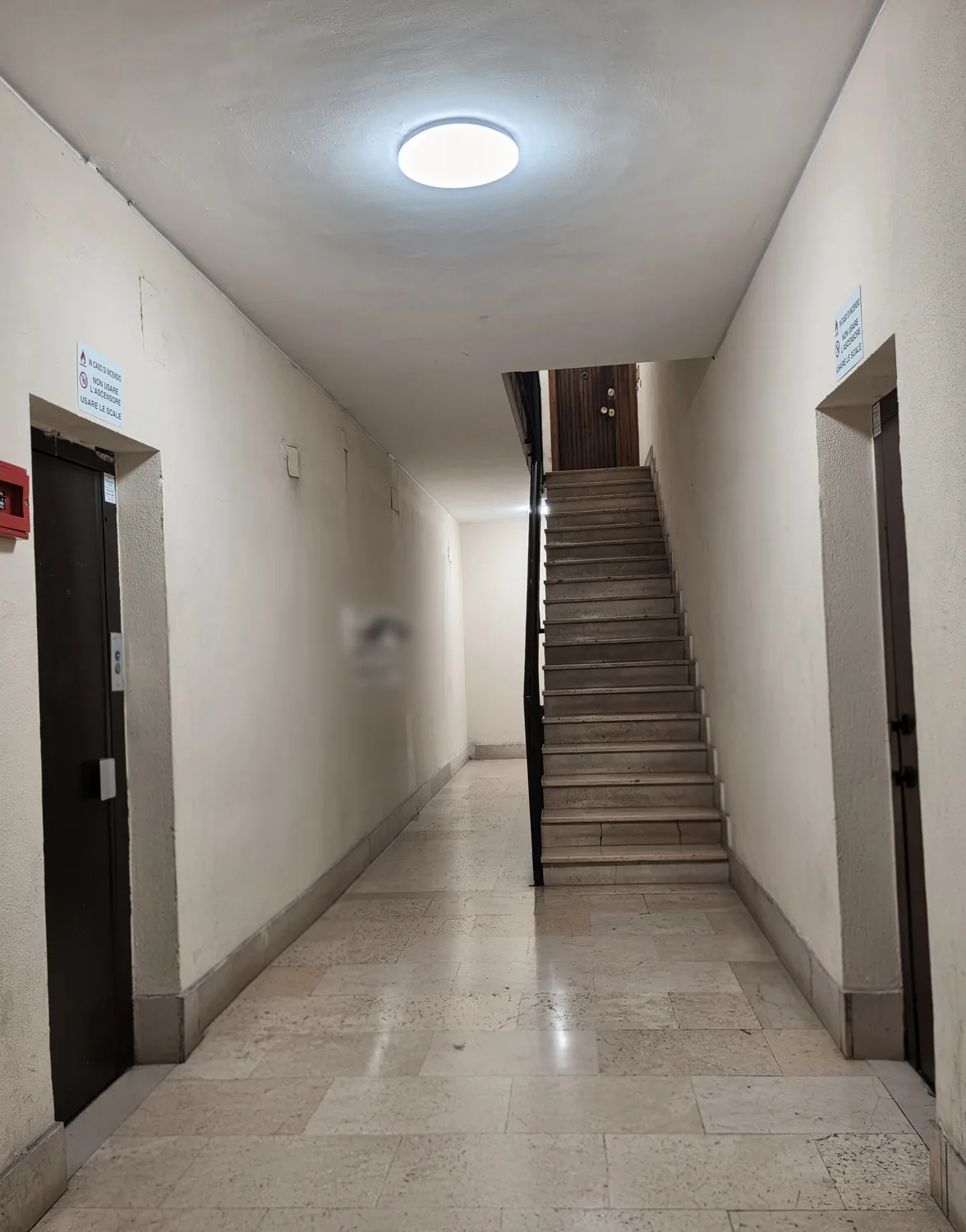 The two lifts in the hall, left and right of the stairs — both go up to the 7th floor